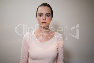 Portrait of young female therapist against wall