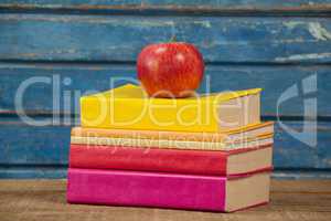 Stack of books and apple