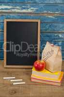 Slate, chalk, apple, lunch bag and books