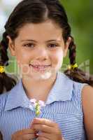 Portrait of smiling girl holding flower