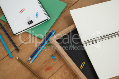 Various school supplies arranged on wooden table