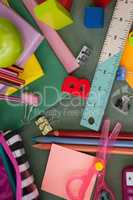 Various school supplies on chalkboard