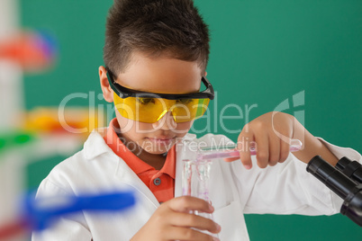 Schoolboy experimenting against green background