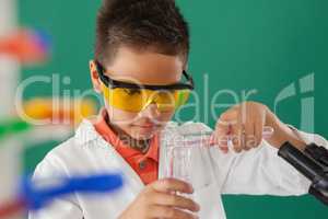 Schoolboy experimenting against green background