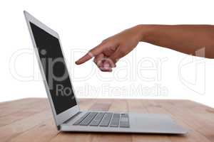 Hand pointing at laptop screen