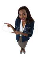 Portrait of smiling businesswoman gesturing while giving presentation
