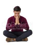 Full length of businessman in prayer position