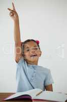 Young girl raising her hand