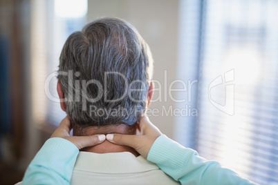 Close-up of female therapist massaging neck to male patient