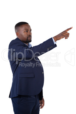 Businessman pressing an invisible virtual screen