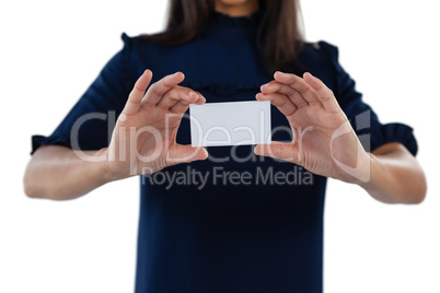 Female executive holding a blank business card