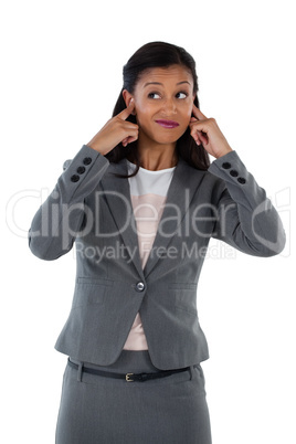 Irritated businesswoman covering her ears