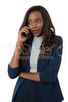 Woman looking away while talking on mobile phone