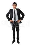 Portrait of young businessman with hand on hip