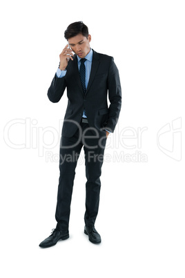 Full length of businessman talking on smartphone