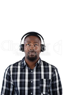 Man listening to music on headphones against white background