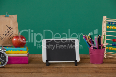 School supplies with digital tablet on wooden table