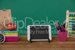 School supplies with digital tablet on wooden table