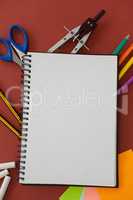 Various school supplies arranged on red background