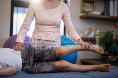 Low section of boy examined by female therapist