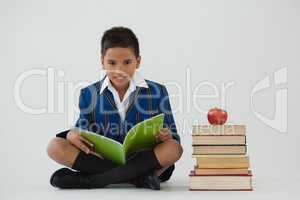 Schoolboy studying against white background