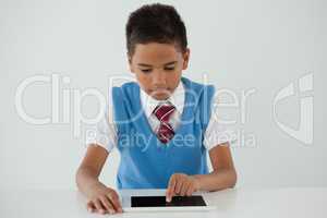 Schoolboy using digital tablet