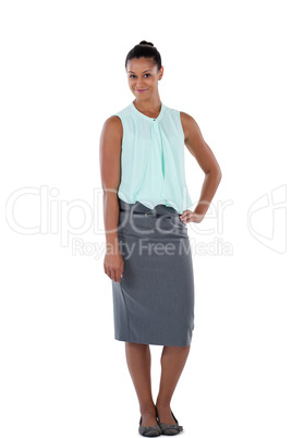 Smiling businesswoman standing with her hand on hip