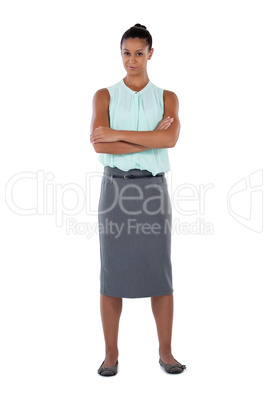 Businesswoman standing with arms crossed against white background