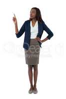 Businesswoman with hand on hip giving presentation