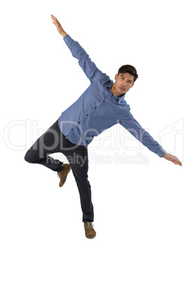Full length of businessman with arms outstretched balancing while standing