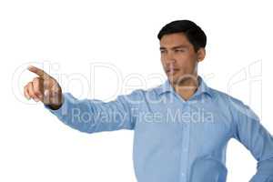 Young businessman touching invisible screen