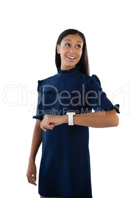 Thoughtful female executive with her smartwatch Thoughtful female executive with her smartwatch