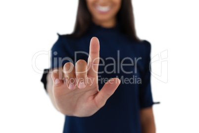 Female executive pressing an invisible virtual screen