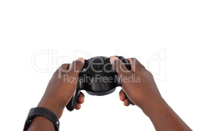 Hand of man playing video game against white background