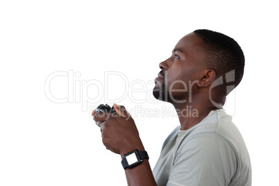 Man playing video game against white background