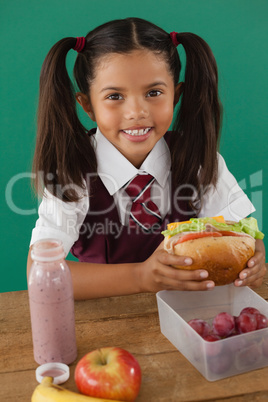 Schoolgirl having sandwich