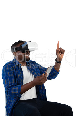 Man gesturing while using virtual reality headset and digital tablet