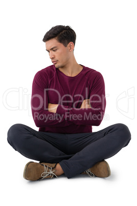 Businessman with arms crossed looking down