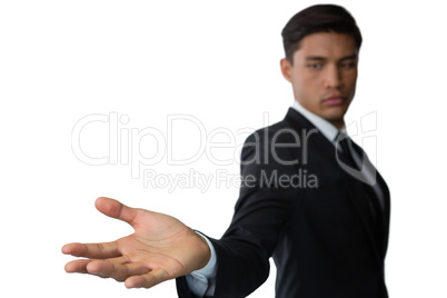 Side view of young businessman looking at hand