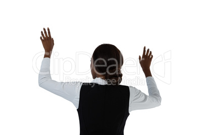 Rear view of businesswoman gesturing while using interface