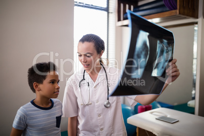 Female therapist and boy with x-ray
