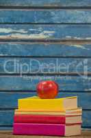 Stack of books and apple