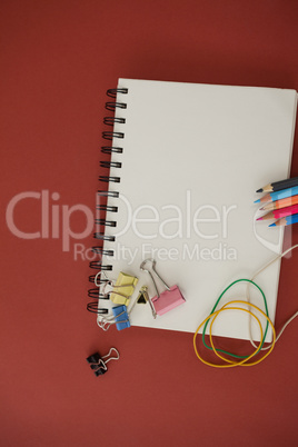 Various school supplies arranged red on background