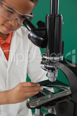 Schoolboy using microscope