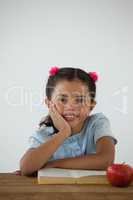 Young girl sitting on her desk