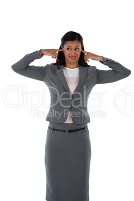 Irritated businesswoman covering her ears