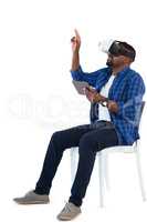 Man gesturing while using virtual reality headset and digital tablet