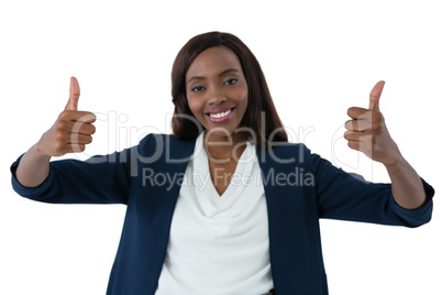 Portrait of happy businesswoman showing thumbs up gesture