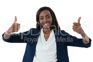 Portrait of happy businesswoman showing thumbs up gesture