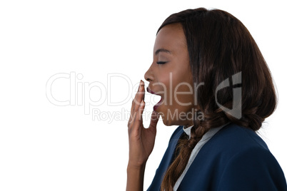 Side view of businesswoman yawning